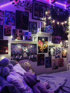 a bedroom with purple lights and pictures on the wall above the bed is decorated with teddy bears