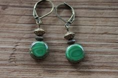 Emerald Green Earrings Czech Glass Earrings Dangle Drop Earrings SMALL EARRINGS Gift for women Color : Emerald green czech glass beads 11mm Finish : Antiqued brass findings Size : Approx 1-3/4 inches including the antique brass lever back Ear wires : Antique Brass lever back Czech Glass Earrings : https://www.etsy.com/shop/NtikArtJewelry?ref=hdr_shop_menu§ion_id=16062218 Thanks for looking Green Metal Drop Clip-on Earrings, Green Hypoallergenic Brass Earrings, Hypoallergenic Green Brass Earrings, Green Adjustable Vintage Earrings, Green Vintage Earrings, Small Dangle Earrings, Emerald Green Earrings, Lotus Earrings, Mixed Metal Earrings