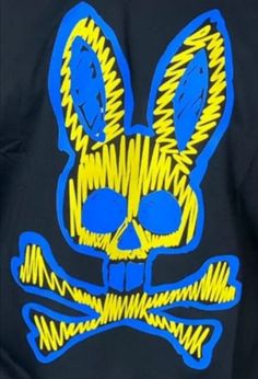 a skull and crossbones is painted on a black t - shirt with blue and yellow accents