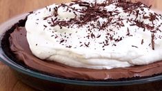 a chocolate pie with white frosting and sprinkles