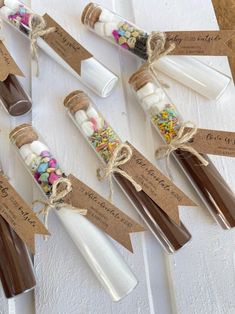 some candy sticks are wrapped in brown paper and tied with twine on the ends