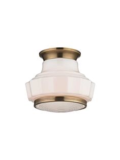 a light fixture with a white glass shade on the bottom and gold trimmings