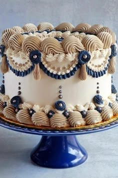 a white and blue decorated cake sitting on top of a table