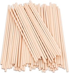 wooden sticks are lined up on a white surface