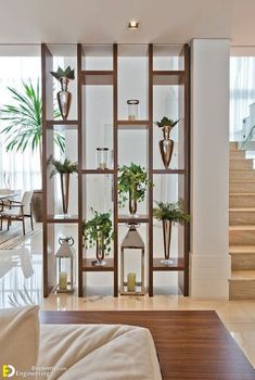 a living room filled with furniture and lots of plants