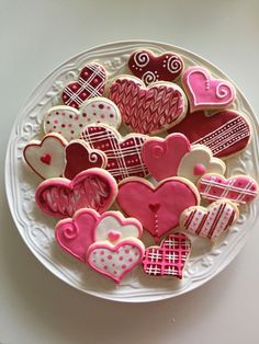 a white plate topped with lots of heart shaped cookies