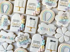 decorated cookies are arranged on a white surface