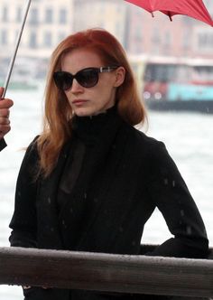 a woman holding an umbrella in the rain