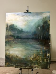 a painting is being displayed on a easel