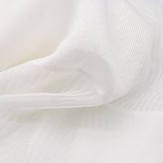 an image of white fabric textured with thin lines and folds on the bottom half of it