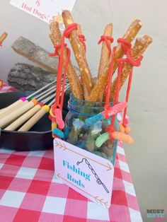 there is a jar full of fish sticks on the table