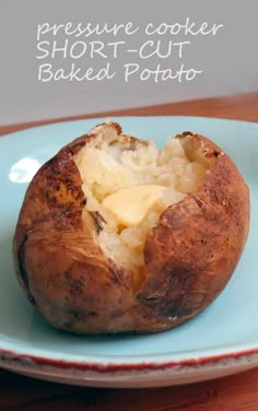 a baked potato on a blue plate with cheese