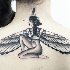 a woman with an egyptian tattoo on her back