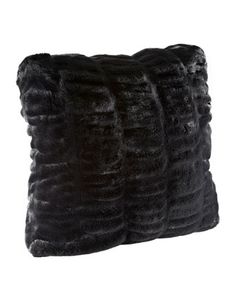 two black fur pillows sitting on top of each other