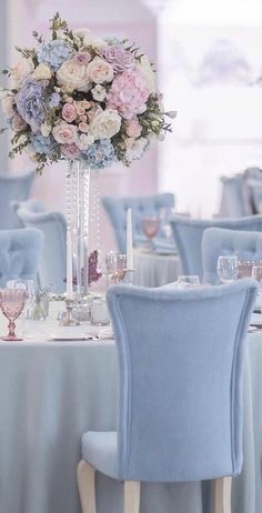 there is a vase with flowers on top of the table at this wedding reception venue