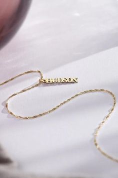 Make a statement with our Vertical Name Necklace, tailored to showcase your unique identity. Perfect for adding a touch of personal charm to any look. #NameNecklace #PersonalizedJewelry #SignatureStyle #thecustomgoodsco #customjewelry #jewelry #handmadejewelry #finejewelry Custom Name 14k Gold Pendant Jewelry, Custom Name 14k White Gold Jewelry, 14k Gold Custom Name Pendant Jewelry, Yellow Gold Necklace For Father's Day Gift, Meaningful Jewelry With Adjustable Chain As A Gift, Customized Yellow Gold Nameplate Jewelry, Customizable Fine Jewelry For Personalized Gift, Silver 14k Gold Name Necklace For Anniversary, White Gold Name Jewelry For Personalized Gift