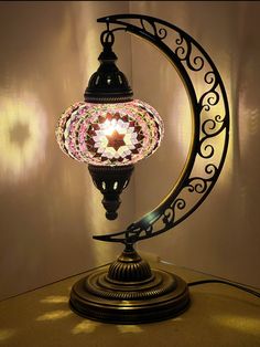 a lamp that is sitting on top of a table next to a light fixture with a star in the center