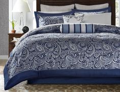 a blue and white comforter set with pillows