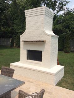 a white brick fireplace sitting on top of a patio