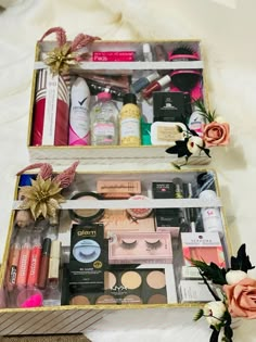 two open boxes with cosmetics and flowers in them