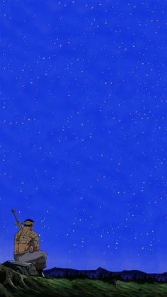 a man sitting on top of a grass covered hill under a sky filled with stars