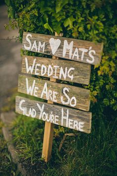 a wooden sign that says sam mat's wedding we are so glad you're here