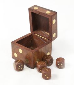 a wooden box with four dice in it and five on the inside, sitting next to each other