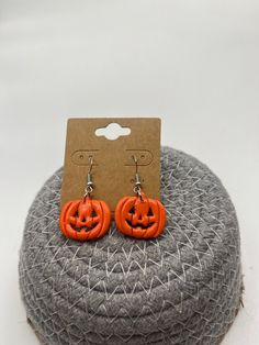 the orange pumpkin earrings are on display