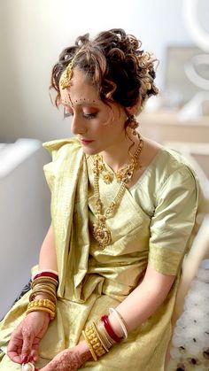 a woman in a yellow dress sitting down