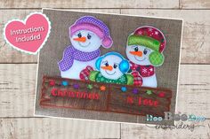 two snowmen with hats and scarfs are sitting in front of a sign that says, instructions included