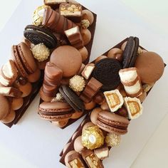 chocolate desserts and cookies arranged in the shape of the letter n on a white surface