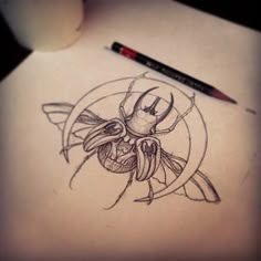 a drawing of a bee on paper next to a pencil and marker with the image of a bug in it