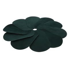 a green flower shaped rug on a white background