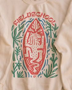 a white sweatshirt with an image of a lion on the front and words nelson school