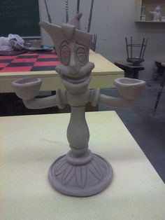 a clay sculpture sitting on top of a table