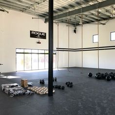 an empty gym with kettles and boxes on the floor