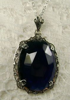 "Pendant Description Custom Inspired by Victorian era designs, I now offer this lovely Antique reproduction in sterling silver. The flawless simulated 22ct faceted blue sapphire is 24mm long (15/16th\") and 18mm in width (3/4th\"). The entire pendant is 1.5\" long and 7/8\" wide. The chain (if chosen) is between 16-18\" in length and is marked 925 as well. Notice the beautiful craftsmanship of the Victorian filigree setting. This pendant necklace is a true reproduction of and old Victorian cameo Silver Sapphire Necklace Hallmarked, Blue Sterling Silver Necklaces Engraved, Elegant Blue Filigree Necklace, Silver Sapphire Oval Pendant Jewelry, Elegant Sapphire Jewelry With Engraving, Victorian Blue Gemstone Necklace, Victorian Style Hallmarked Sapphire Jewelry, Handmade Elegant Sapphire Jewelry, Elegant Engraved Sapphire Jewelry