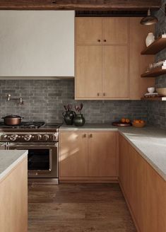 a kitchen with wooden cabinets and stainless steel appliances