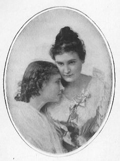 an old black and white photo of two women with hair pulled back to the side