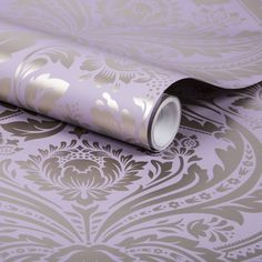 a purple and gold wallpaper with an ornate design on it's side,