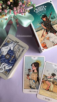 three tarot cards are sitting on a table