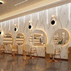 the interior of a hair salon with chairs and mirrors on the wall, along with lights hanging from the ceiling