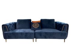 a blue couch with two pillows on the back and an orange pillow at the end