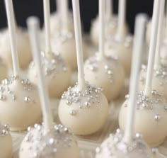 cake pops with white frosting and silver sprinkles