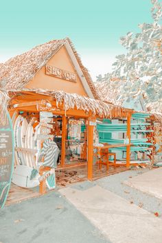 the front of a store that has been decorated in orange and turquoise colors with snow on it