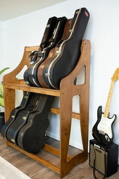 guitars are lined up on a wooden shelf