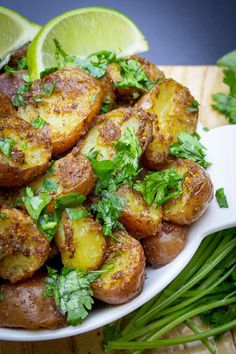 a white plate topped with potatoes covered in cilantro