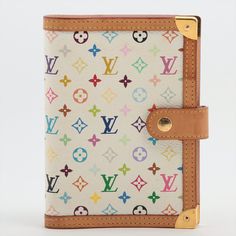 The Louis Vuitton Multicolor Agenda PM Notebook Cover in White is an elegant and functional accessory designed to keep your notes and schedule organized. Crafted from Louis Vuitton's iconic Monogram Multicolor canvas, the notebook cover showcases a classic and sophisticated white color. The Monogram Multicolor canvas features the LV monogram pattern in various colors against a white background, creating a timeless and refined look. The PM size is compact and practical, making it perfect for carr Louie Vuttion, Louis Vuitton Ring, Louis Vuitton Agenda Pm, Calendar Inserts, Louis Vuitton Agenda, Pm Monogram, Agenda Cover, Louis Vuitton Multicolor, Small Ring