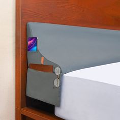 there is a cell phone sticking out of the pocket of a bed