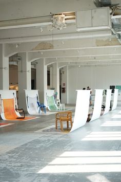 an empty room with several chairs and one chair on the ground in front of it